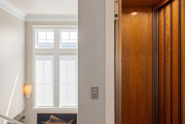 interior details with elevator and crown molding