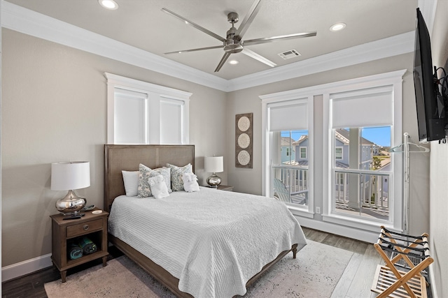 bedroom with recessed lighting, visible vents, wood finished floors, and crown molding