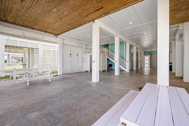 exterior space featuring finished concrete floors and wooden ceiling