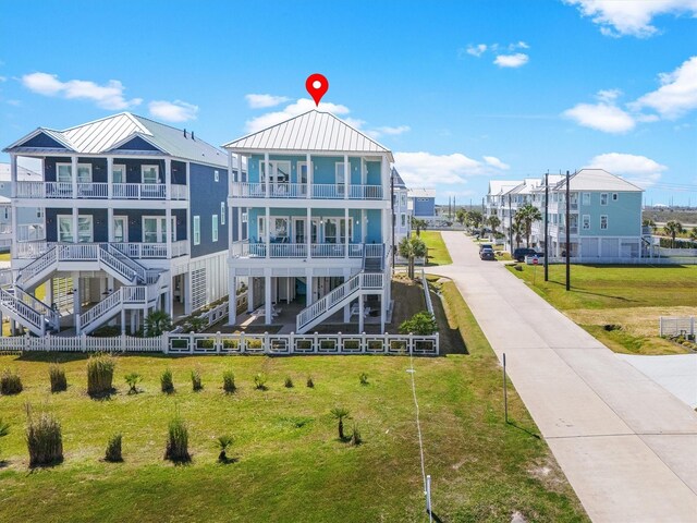 view of home's community featuring stairway, a residential view, and a lawn