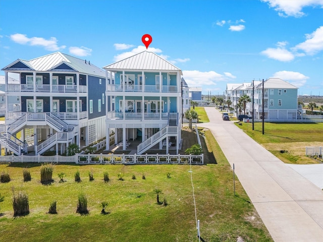 exterior space featuring a residential view, a lawn, and stairs