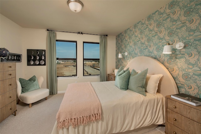 bedroom featuring light carpet and wallpapered walls