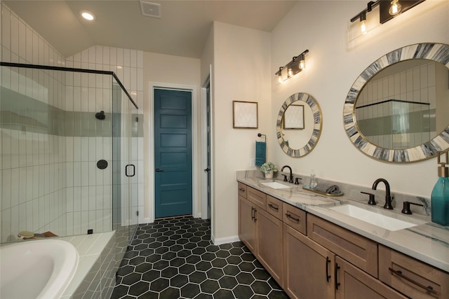 full bathroom with a shower stall, double vanity, visible vents, and a sink