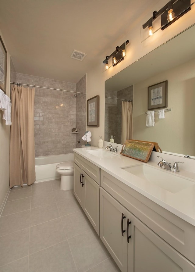 bathroom featuring a sink, visible vents, toilet, and tile patterned floors