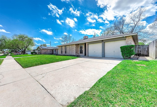 view of front of house with fence, a chimney, a front lawn, concrete driveway, and a garage