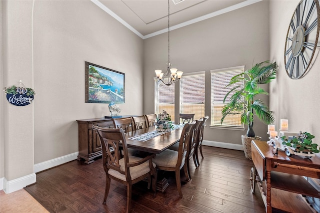 dining room featuring baseboards, a notable chandelier, dark wood finished floors, and ornamental molding