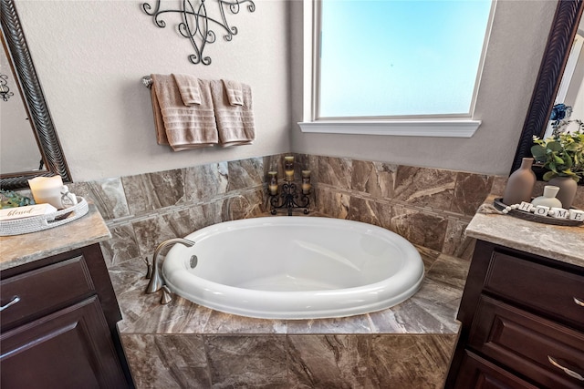 full bathroom featuring a bath and vanity