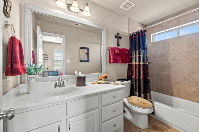 bathroom with visible vents, toilet, shower / tub combo with curtain, tile patterned flooring, and vanity