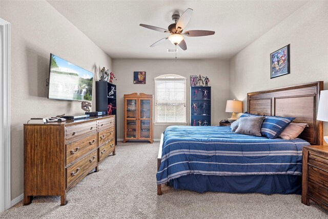 bedroom with light colored carpet, a ceiling fan, and baseboards