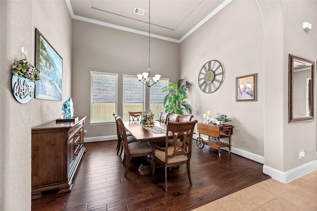 dining space featuring baseboards, a notable chandelier, dark wood finished floors, and crown molding