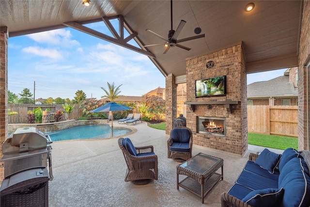 view of patio / terrace with a ceiling fan, area for grilling, a fenced backyard, and a fenced in pool