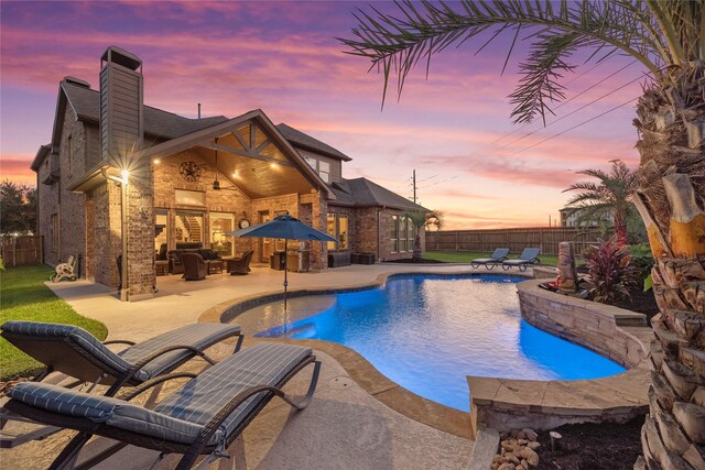 view of swimming pool featuring a fenced in pool, a fenced backyard, and a patio area