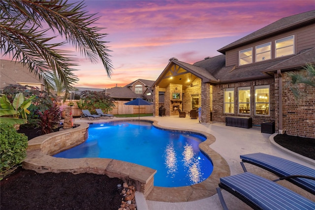 pool at dusk featuring a patio area, a fenced in pool, and fence