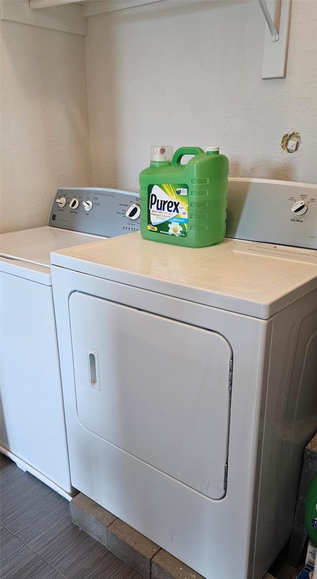 washroom with washing machine and clothes dryer and laundry area