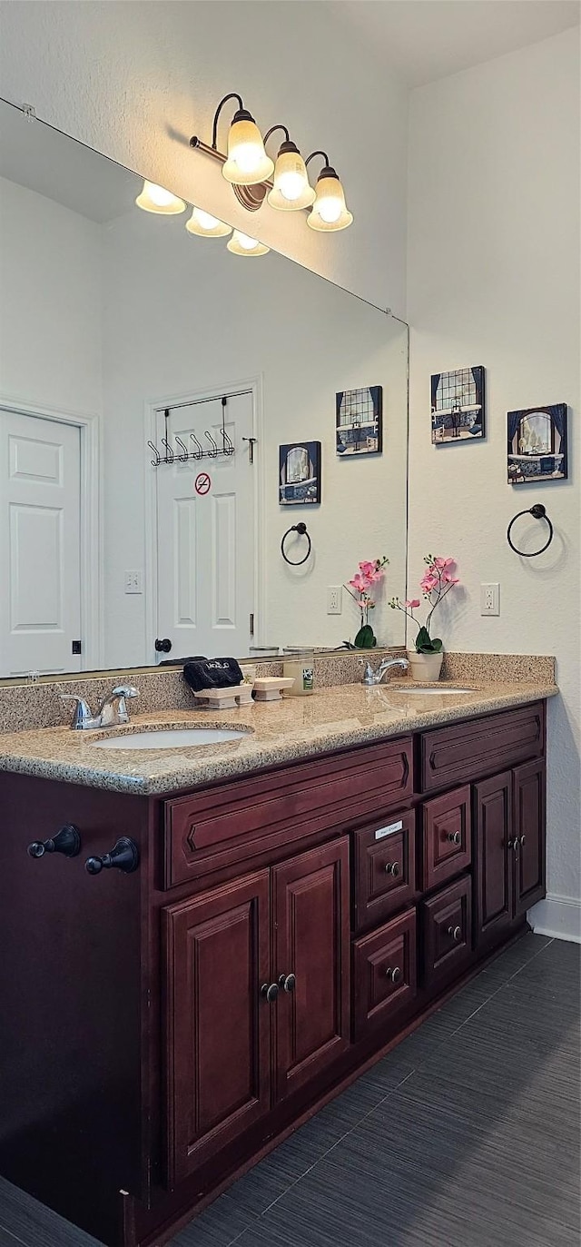 bathroom featuring double vanity and a sink