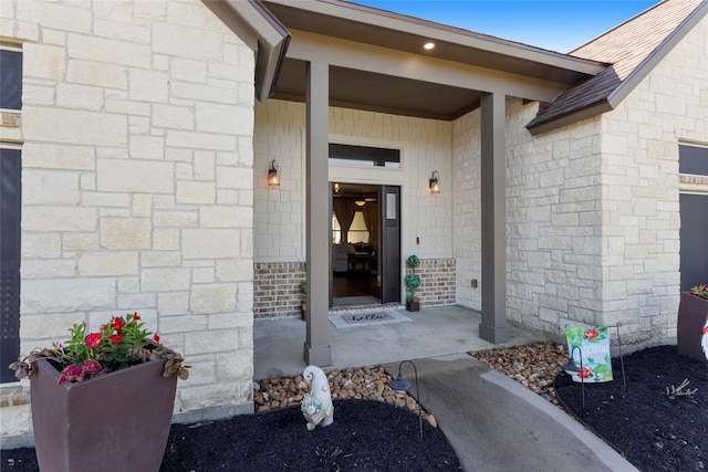 property entrance featuring roof with shingles