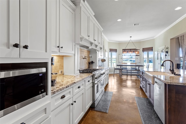 kitchen featuring white cabinetry, tasteful backsplash, appliances with stainless steel finishes, and a sink