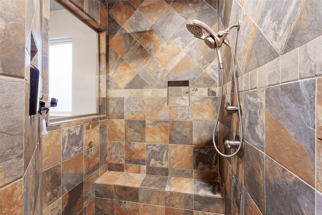 interior details featuring tiled shower