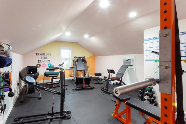 exercise room with lofted ceiling, a wall unit AC, recessed lighting, and baseboards