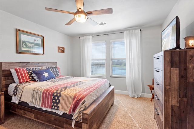 bedroom featuring ceiling fan, baseboards, and light carpet