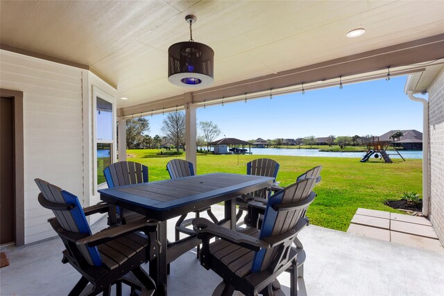 view of patio / terrace featuring a water view and outdoor dining space