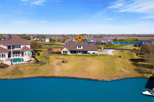 drone / aerial view with a residential view and a water view