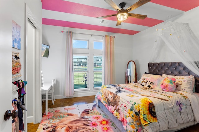 bedroom with visible vents, baseboards, and a ceiling fan