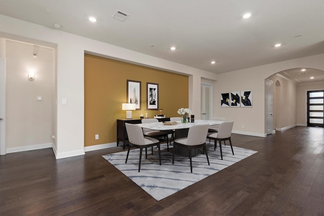 dining area featuring recessed lighting, visible vents, arched walkways, and wood finished floors