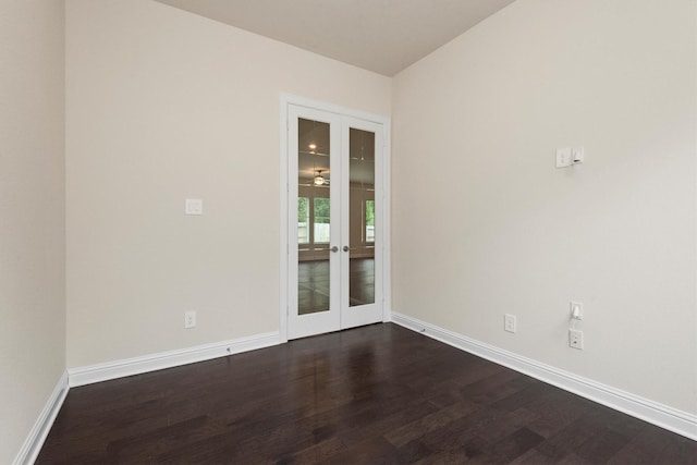 unfurnished room featuring dark wood-style floors, french doors, and baseboards