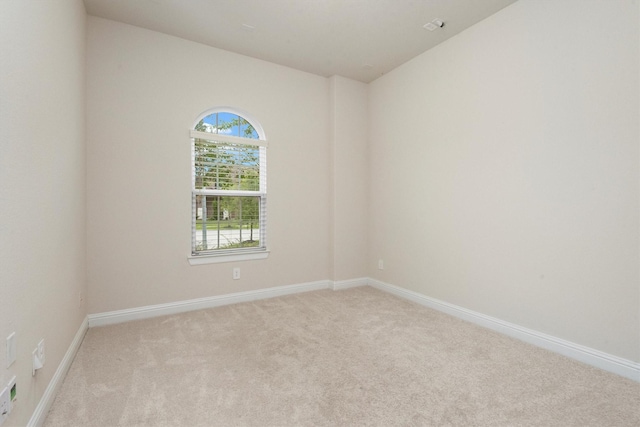 empty room featuring baseboards and carpet floors