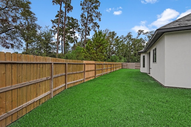 view of yard with a fenced backyard