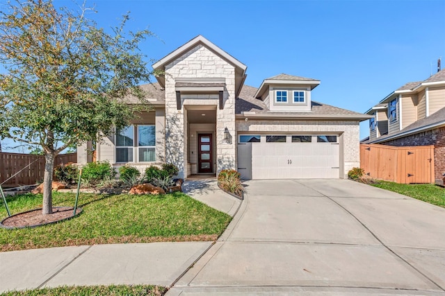 view of front of property featuring brick siding, a front lawn, fence, concrete driveway, and an attached garage