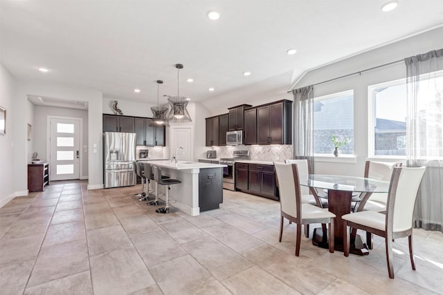 kitchen featuring plenty of natural light, appliances with stainless steel finishes, light countertops, and decorative backsplash