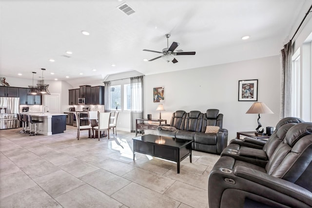 living area with light tile patterned floors, visible vents, recessed lighting, and ceiling fan