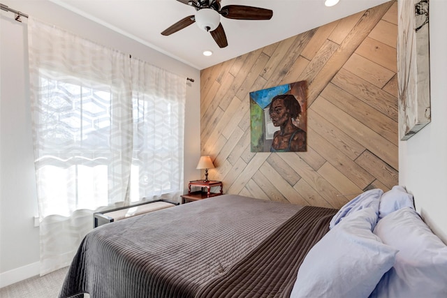 bedroom with wooden walls, recessed lighting, a ceiling fan, and baseboards