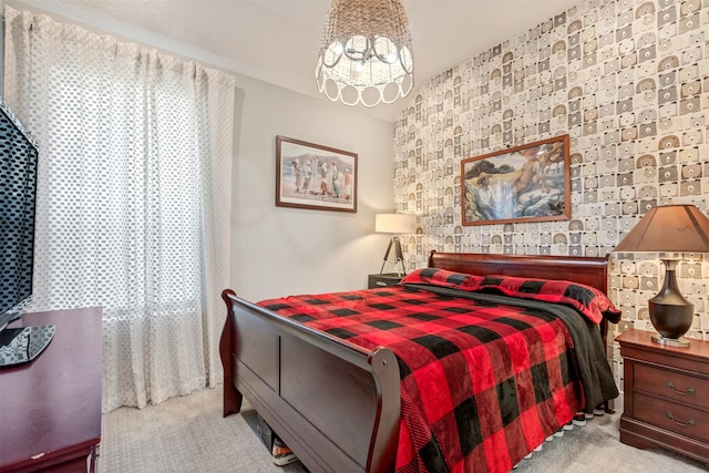 carpeted bedroom with a notable chandelier