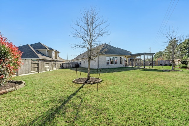 view of yard with a pergola and a fenced backyard