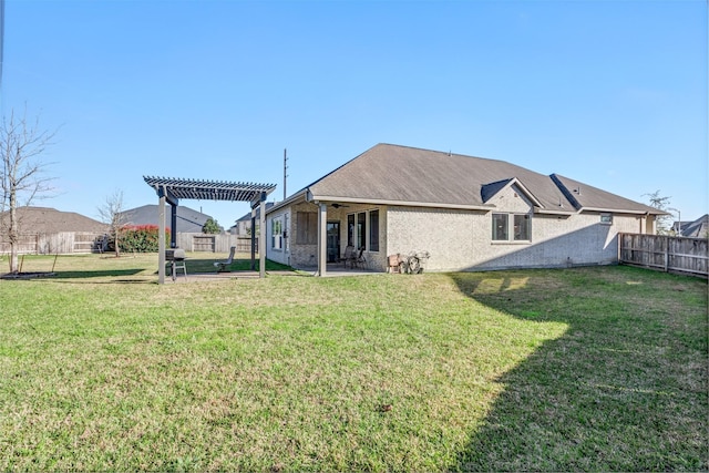 back of property featuring a patio area, a fenced backyard, a pergola, and a lawn