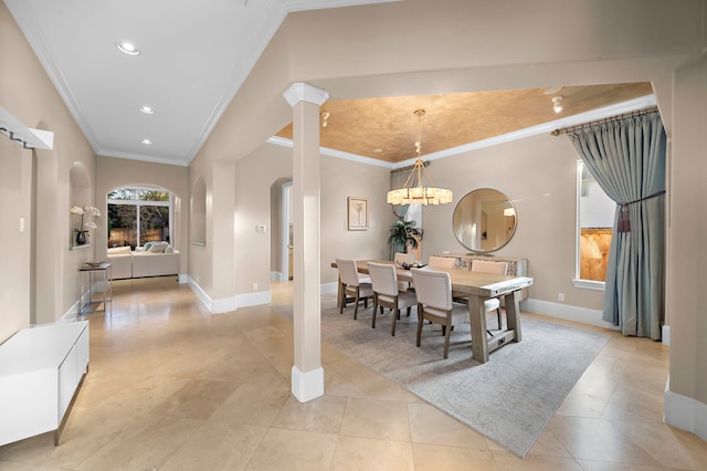 dining room featuring arched walkways, recessed lighting, baseboards, and ornamental molding