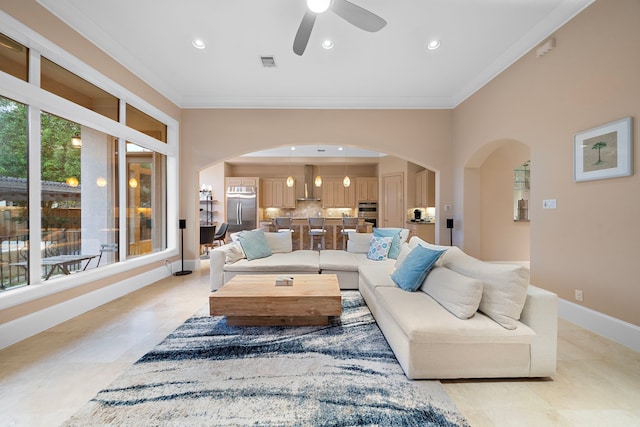 living room featuring visible vents, baseboards, ornamental molding, recessed lighting, and arched walkways