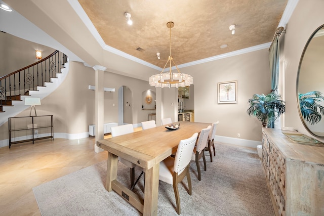 dining area with crown molding, baseboards, stairs, arched walkways, and ornate columns