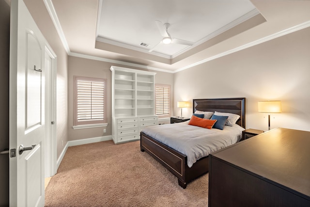 bedroom featuring visible vents, baseboards, a tray ceiling, ornamental molding, and light colored carpet