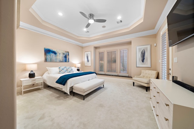 bedroom with visible vents, a raised ceiling, light colored carpet, and ornamental molding