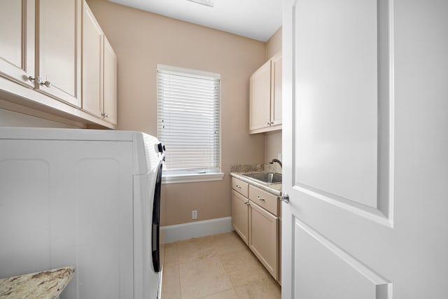 clothes washing area featuring baseboards, washer and dryer, light tile patterned flooring, cabinet space, and a sink