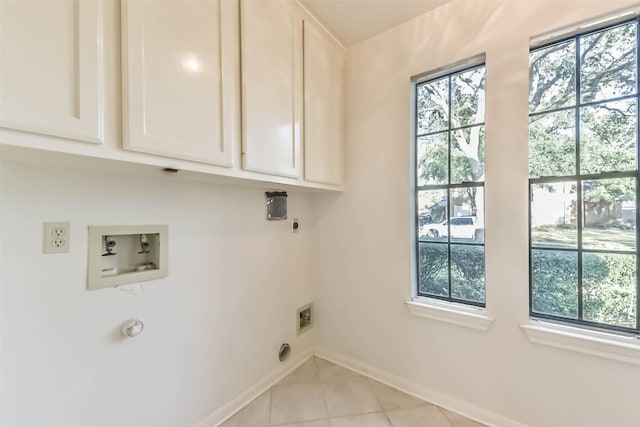 clothes washing area featuring baseboards, washer hookup, light tile patterned floors, cabinet space, and electric dryer hookup