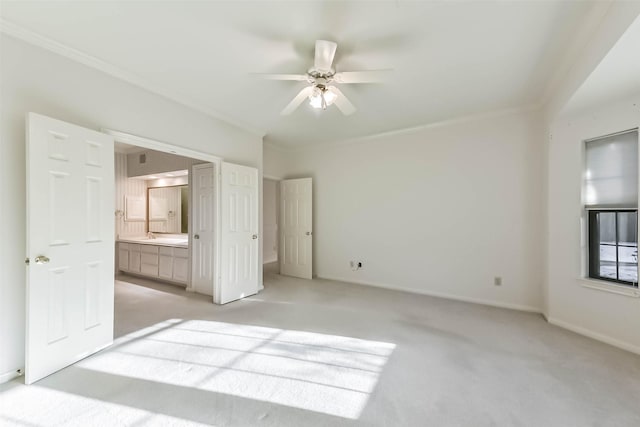 unfurnished bedroom with connected bathroom, crown molding, baseboards, ceiling fan, and light colored carpet