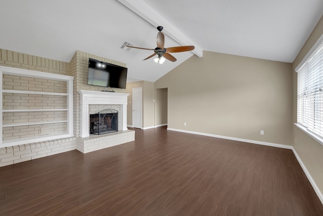 unfurnished living room with dark wood finished floors, baseboards, a brick fireplace, ceiling fan, and vaulted ceiling with beams