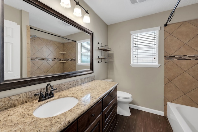 full bathroom featuring wood tiled floor, baseboards, toilet, and vanity