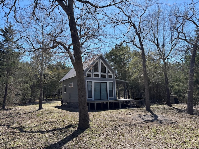 back of property featuring a forest view