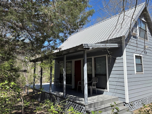 exterior space with crawl space, a wooden deck, and metal roof